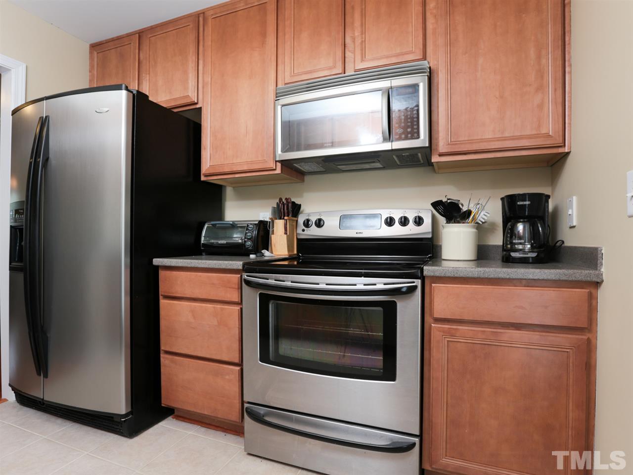 9908 Layla Avenue Raleigh, NC 27617 - Photo 8 of 25 a kitchen with stainless steel appliances granite countertop a refrigerator stove and microwave