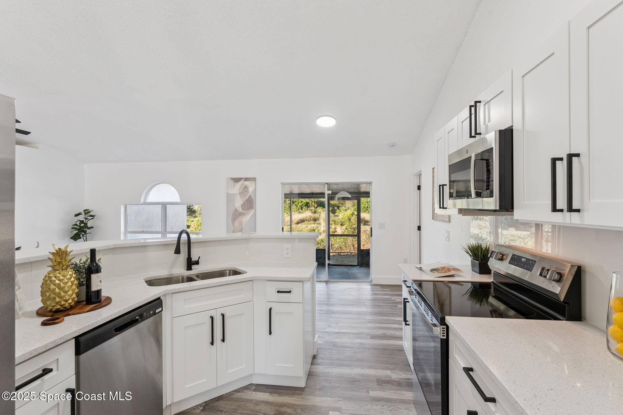 6200 Edison Street Cocoa, FL 32927 - Photo 11 of 21 a kitchen with stainless steel appliances a sink stove and refrigerator