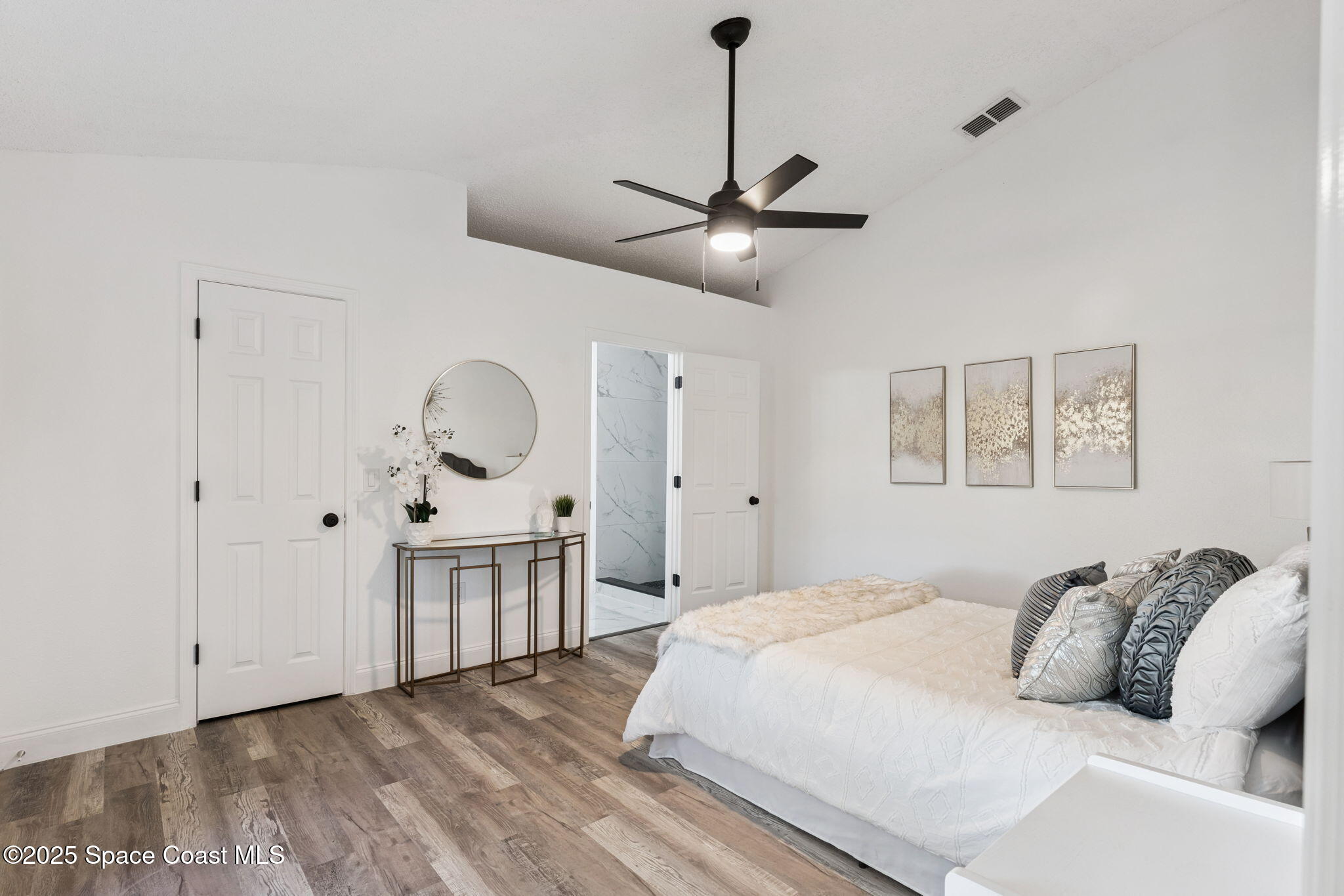 6200 Edison Street Cocoa, FL 32927 - Photo 15 of 21 a bedroom with a large bed and a chandelier