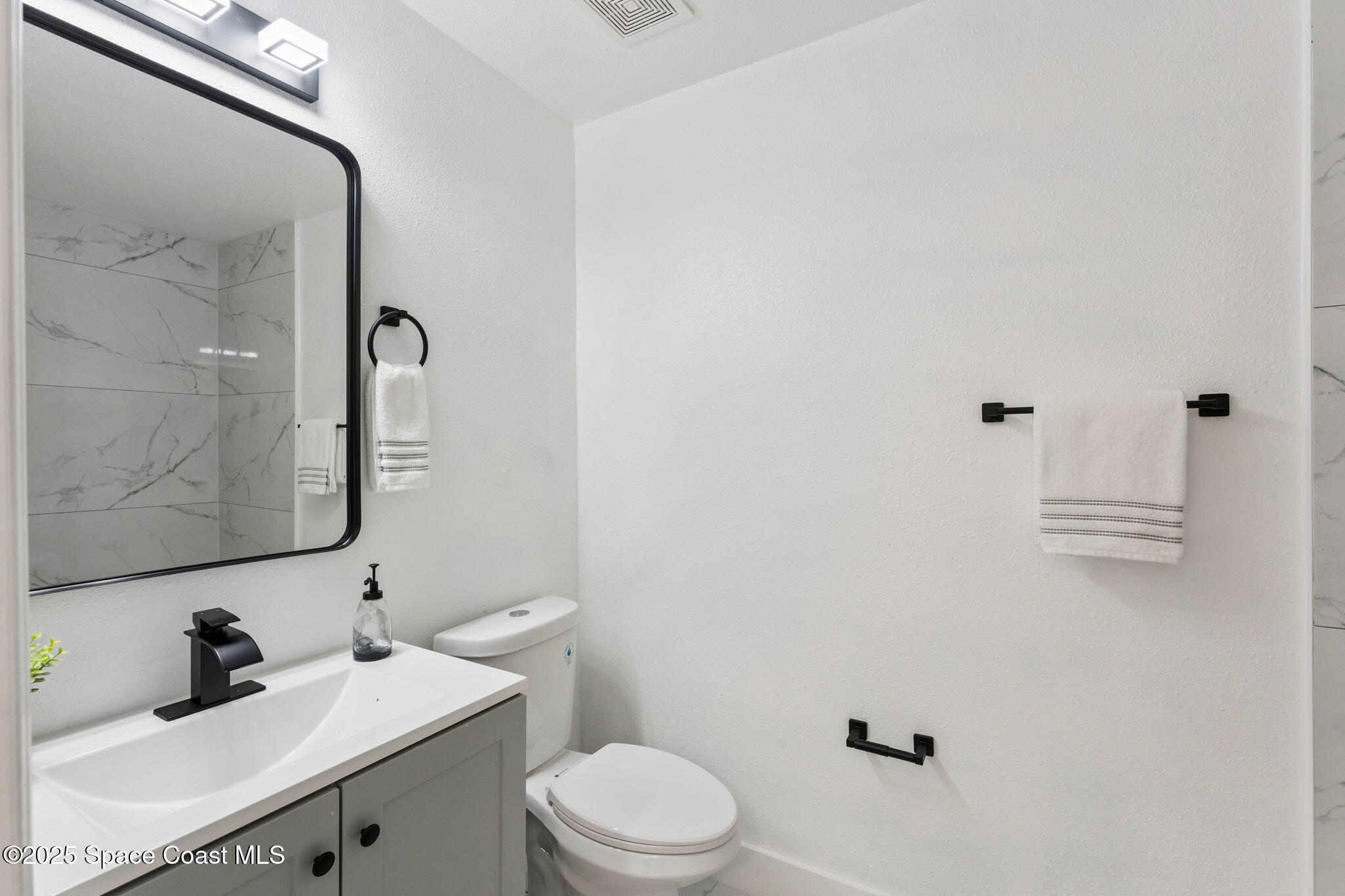6200 Edison Street Cocoa, FL 32927 - Photo 19 of 21 a bathroom with a sink a toilet and shower