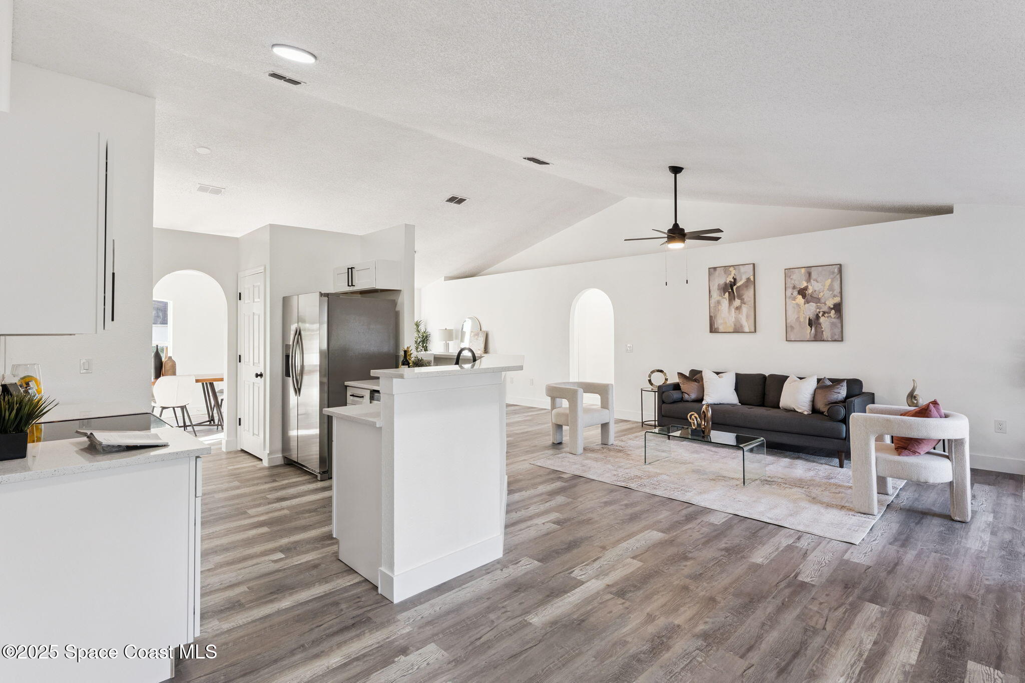 6200 Edison Street Cocoa, FL 32927 - Photo 8 of 21 a living room with furniture a refrigerator and kitchen view