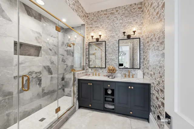 a bathroom with a double vanity sink mirror and shower