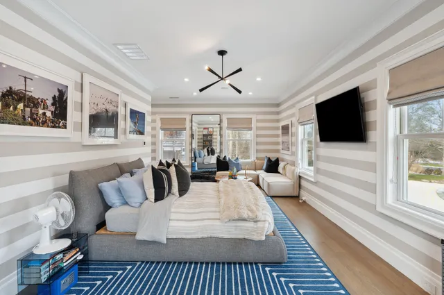 a living room with furniture a flat screen tv and a fireplace