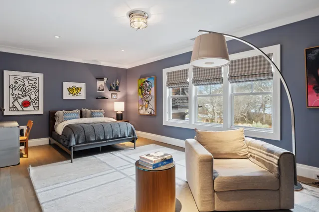 a bedroom with a large bed and a couch