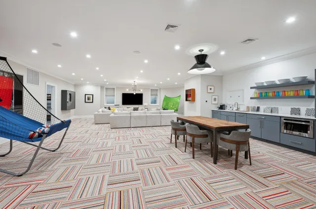 a large kitchen with a table and chairs