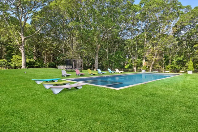 a view of a swimming pool with a yard
