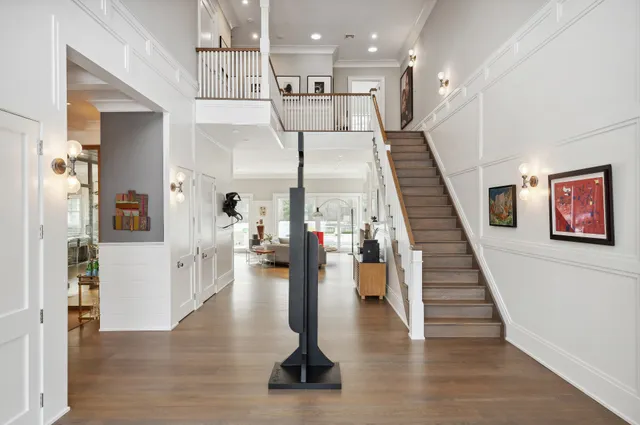 a view of entryway and hall with wooden floor