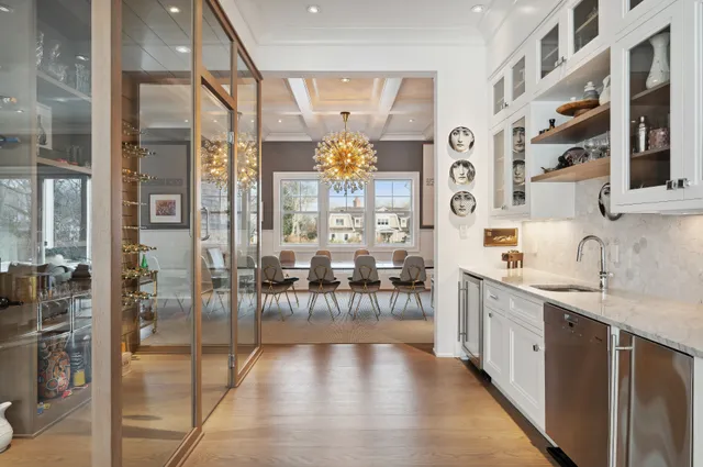 a large white kitchen with granite countertop a lot of counter space and glass door