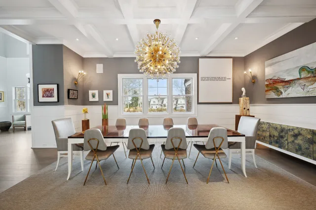 a view of a dining room with furniture and a chandelier