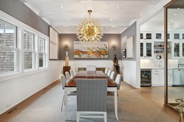 a view of a dining room with furniture and chandelier