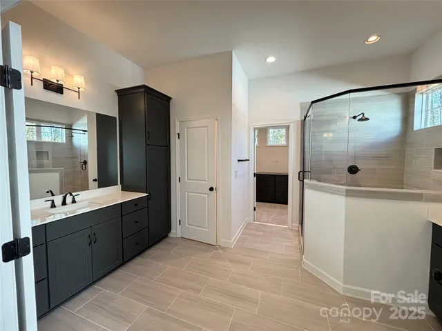 a bathroom with a sink vanity and mirror