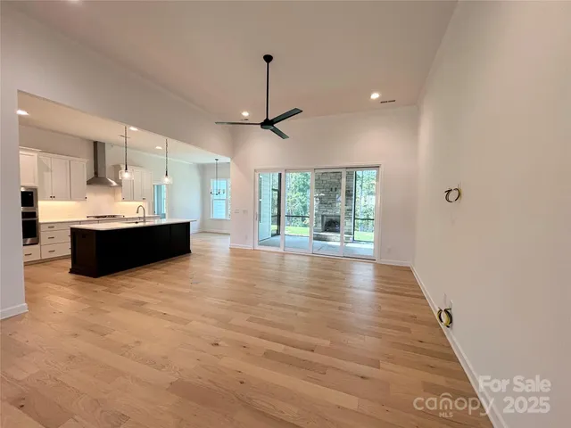 a view of kitchen and hall with wooden floor