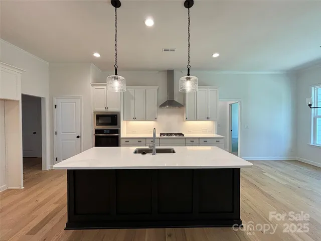 a large kitchen with a table and chairs