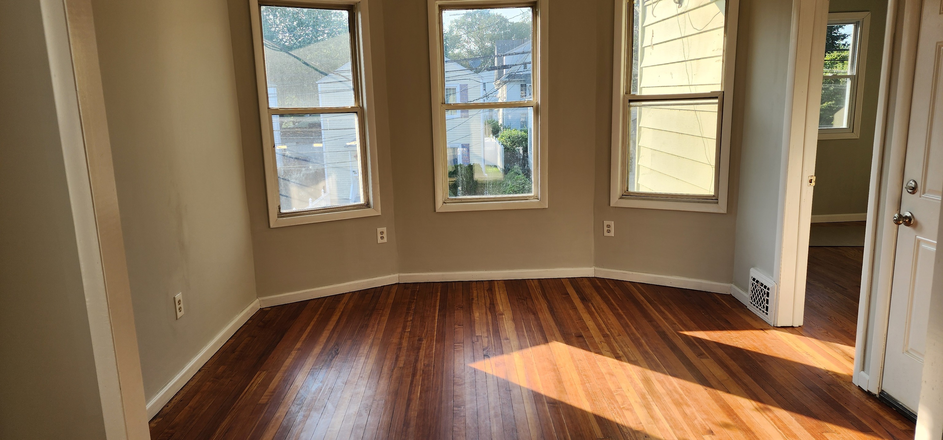 539 Garfield Avenue Bridgeport, CT 06606 - Photo 3 of 7 a view of an empty room with wooden floor and a window