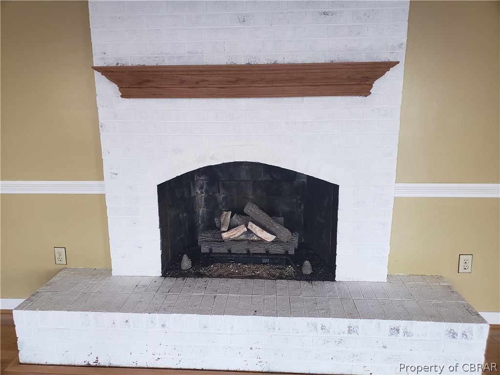 589 Brandon Point Road Locust Hill, VA 23092 - Photo 15 of 39 Cozy propane fireplace with freshly whitewashed brick.