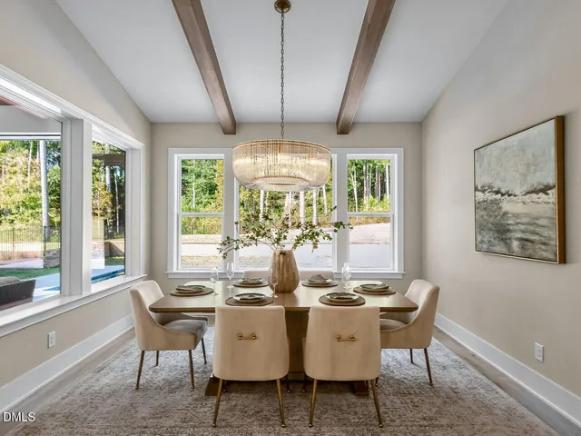 a dining room with furniture a chandelier and wooden floor