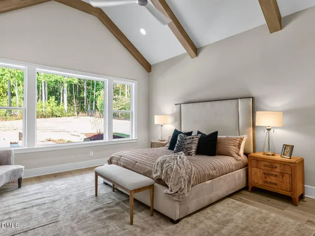 a bedroom with a bed and a large window