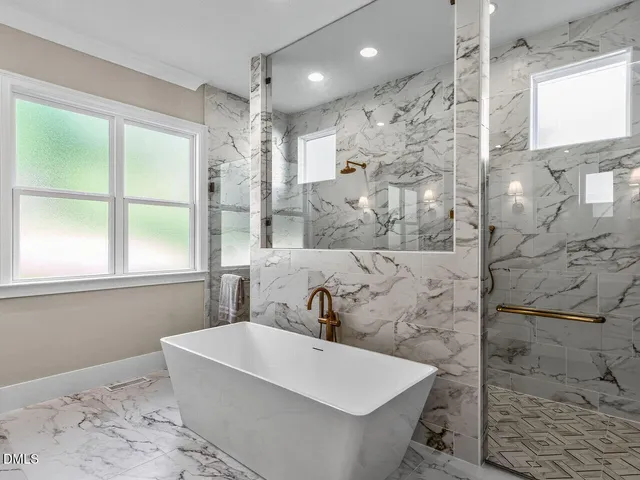 a bathroom with a bathtub and shower