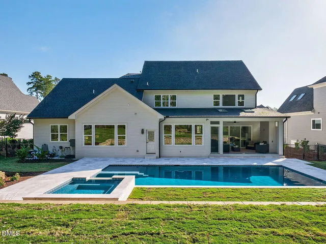 a front view of house with yard and swimming pool
