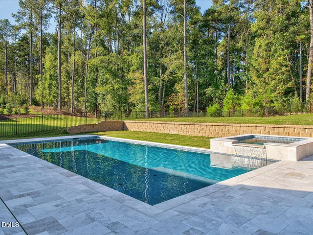 a view of a swimming pool and a yard