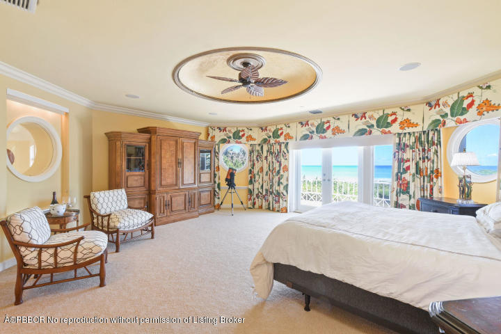515 South Beach Road Hobe Sound, FL 33455 - Photo 14 of 30 a bedroom with a bed a mirror and a large window