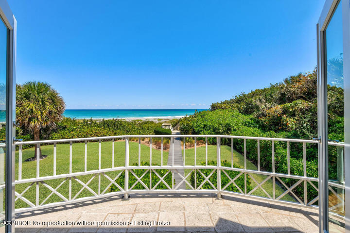 515 South Beach Road Hobe Sound, FL 33455 - Photo 15 of 30 a view of a chair and a small yard