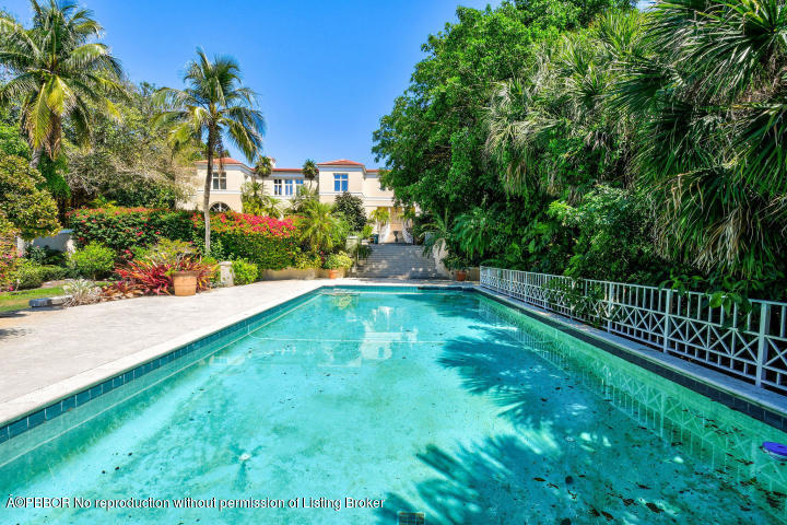 515 South Beach Road Hobe Sound, FL 33455 - Photo 23 of 30 a view of yard with swimming pool and trees in the background