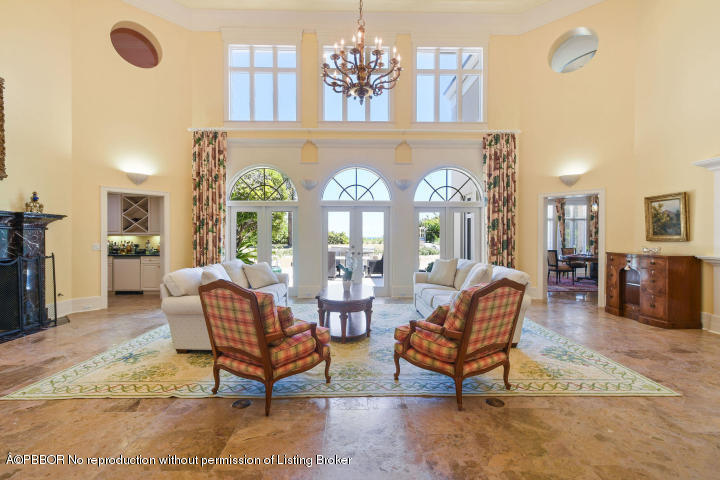 515 South Beach Road Hobe Sound, FL 33455 - Photo 7 of 30 a living room with furniture chandelier and a rug