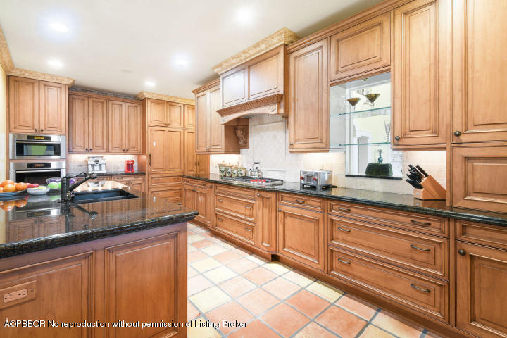515 South Beach Road Hobe Sound, FL 33455 - Photo 9 of 30 a kitchen with granite countertop a sink window and cabinets