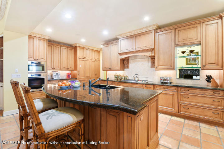 515 South Beach Road Hobe Sound, FL 33455 - Photo 10 of 30 a kitchen with granite countertop sink window and chairs