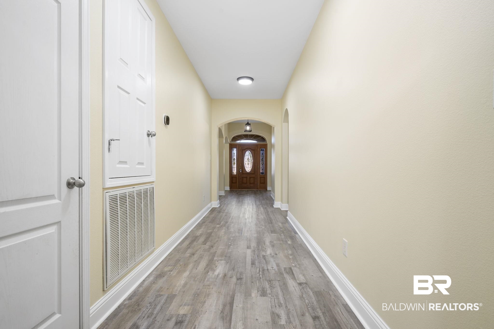 25234 Fairfax Road Daphne, AL 36526 - Photo 14 of 45 Corridor with arched walkways and wood finished floors