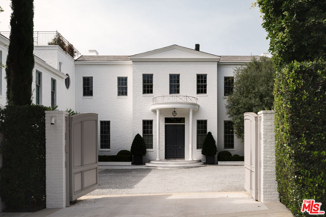 a view of a white house with a outdoor space