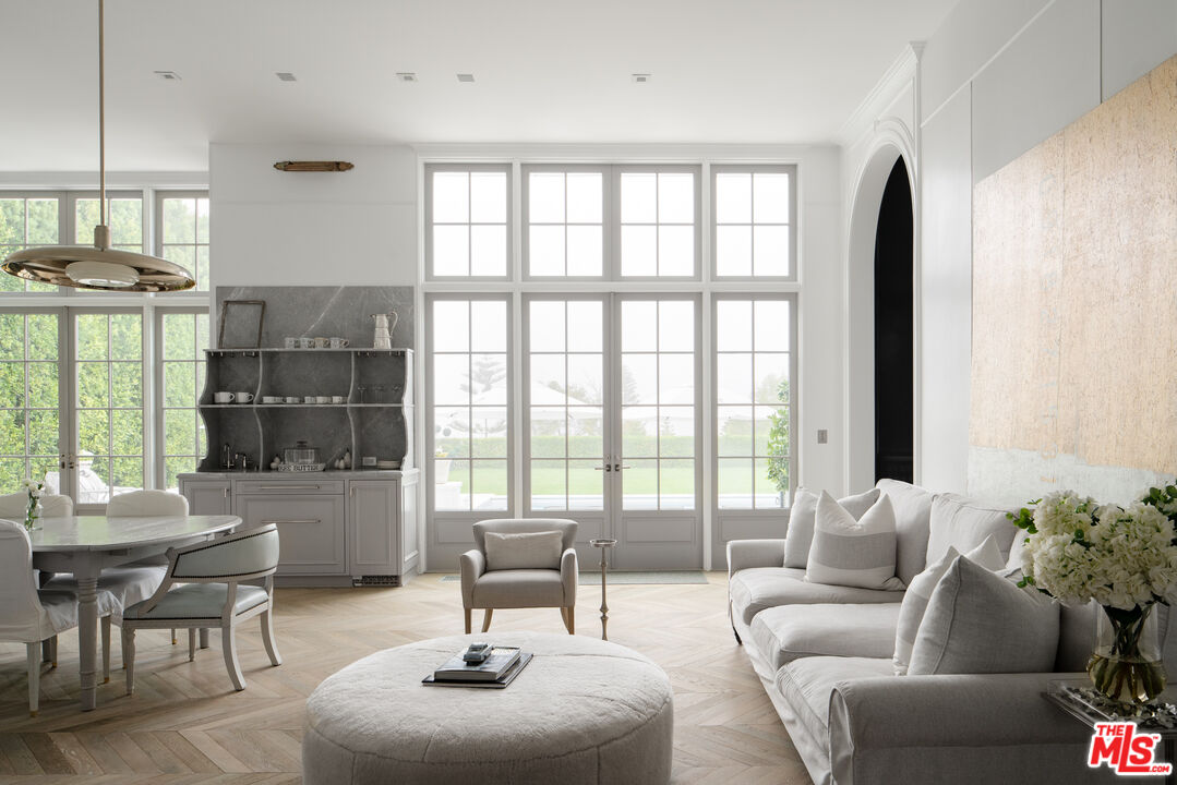 227 North Tigertail Road Los Angeles, CA 90049 - Photo 12 of 42 a living room with furniture and a floor to ceiling window