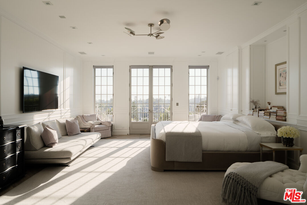 227 North Tigertail Road Los Angeles, CA 90049 - Photo 16 of 42 a bedroom with bed and a flat screen tv