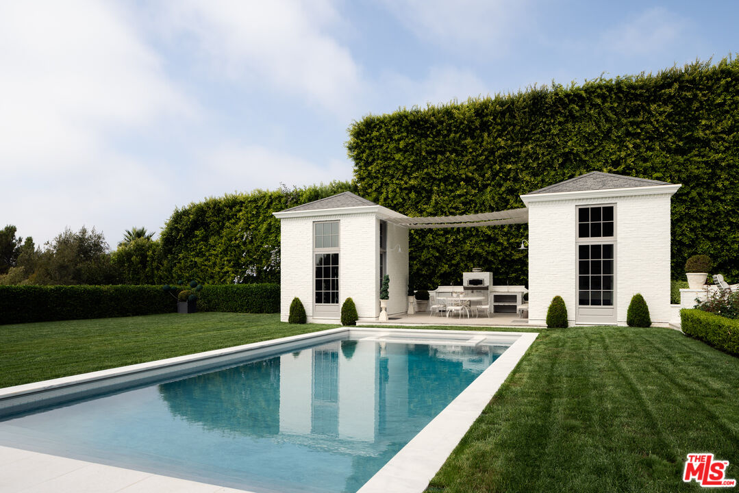227 North Tigertail Road Los Angeles, CA 90049 - Photo 28 of 42 a view of house with swimming pool and yard
