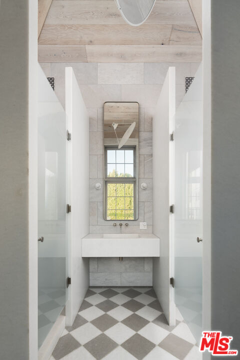 227 North Tigertail Road Los Angeles, CA 90049 - Photo 41 of 42 a bathroom with a sink and a mirror