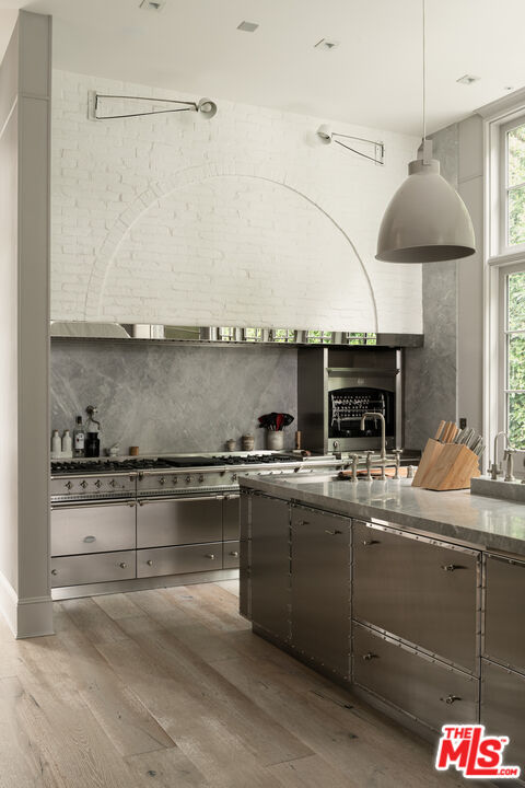 227 North Tigertail Road Los Angeles, CA 90049 - Photo 8 of 42 a kitchen with stainless steel appliances granite countertop a sink a stove and a microwave