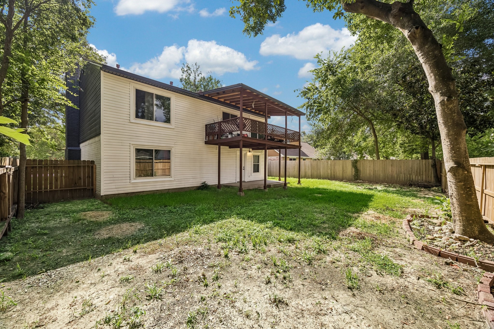 23319 Whispering Willow Drive Spring, TX 77373 - Photo 27 of 31 Alternate view of backyard with dual level covered patios.