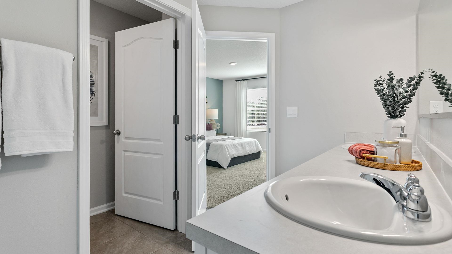 177 Redbud Road Palm Coast, FL 32137 - Photo 16 of 33 a en suite bathroom with a sink and mirror