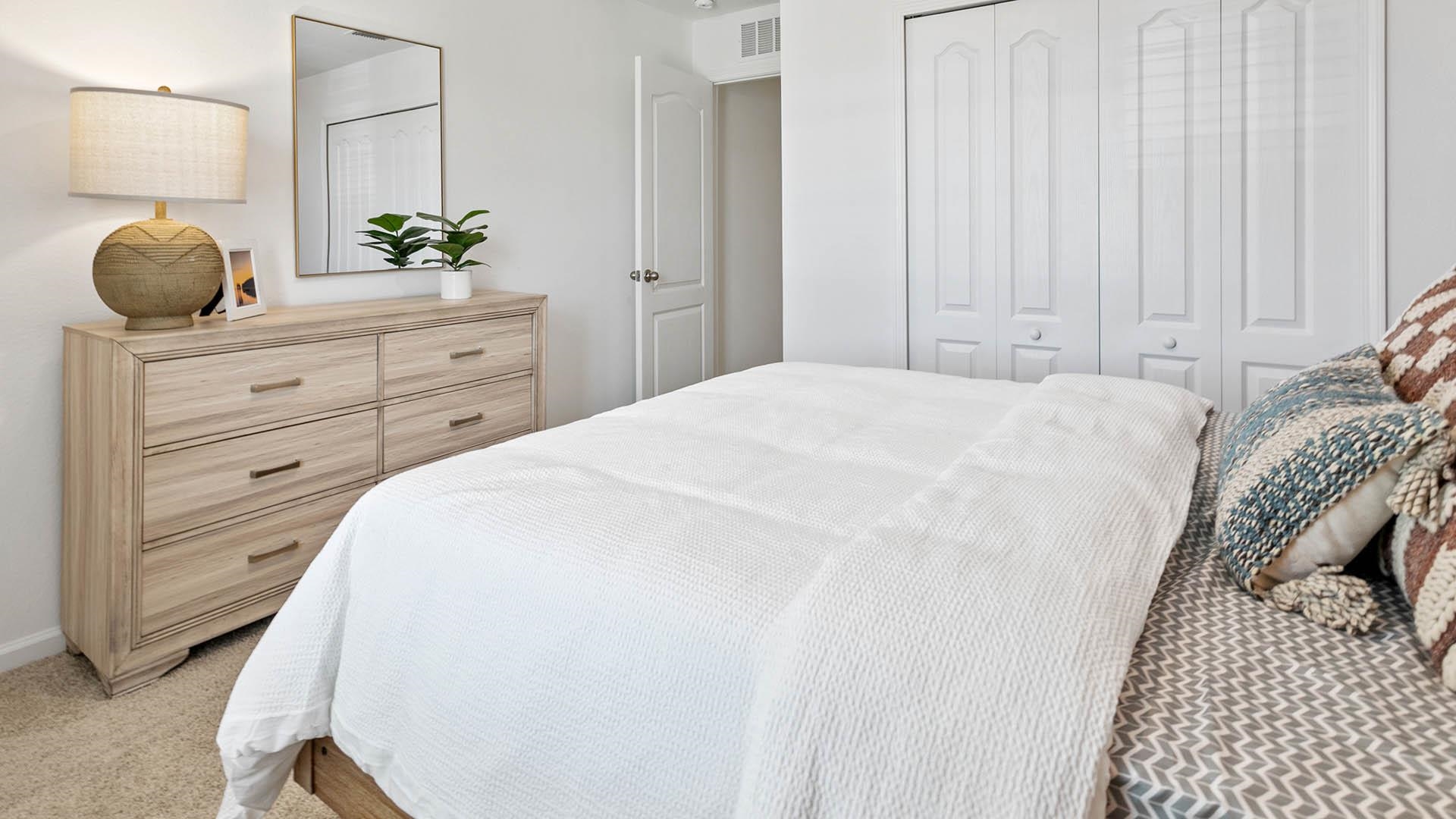 177 Redbud Road Palm Coast, FL 32137 - Photo 20 of 33 a bedroom with a bed and a potted plant