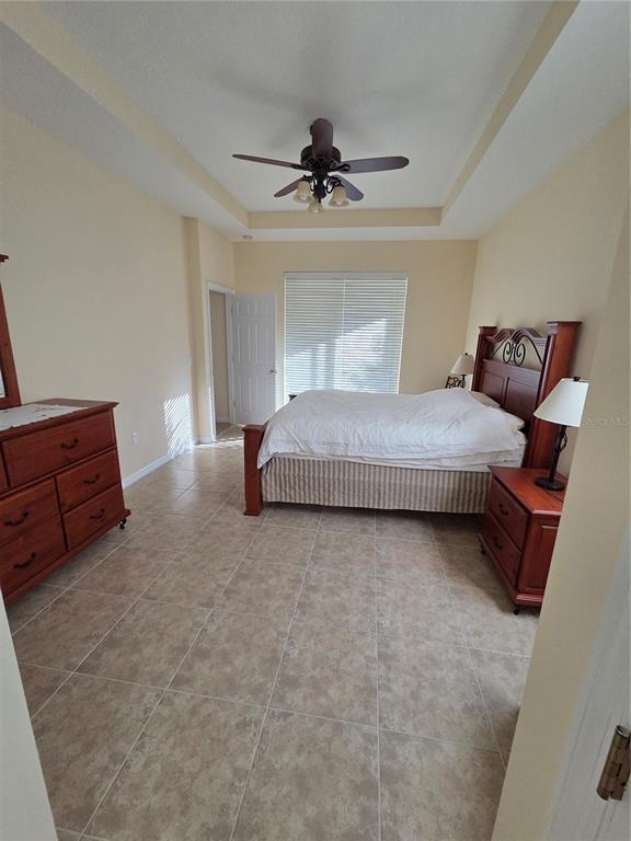 527 Safe Harbor Drive Edgewater, FL 32141 - Photo 11 of 33 a spacious bedroom with a bed and window