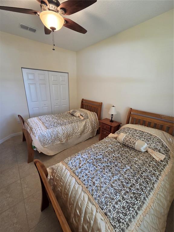 527 Safe Harbor Drive Edgewater, FL 32141 - Photo 19 of 33 a bedroom with two beds and lamp