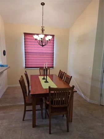 a dining room with furniture and window