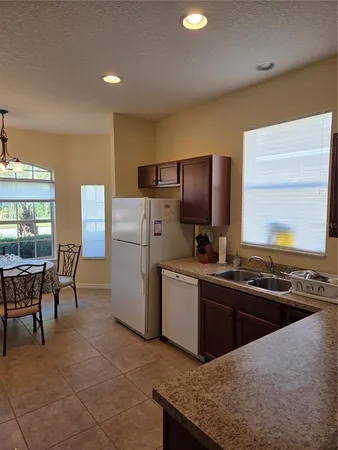 a kitchen with refrigerator cabinets and dining table