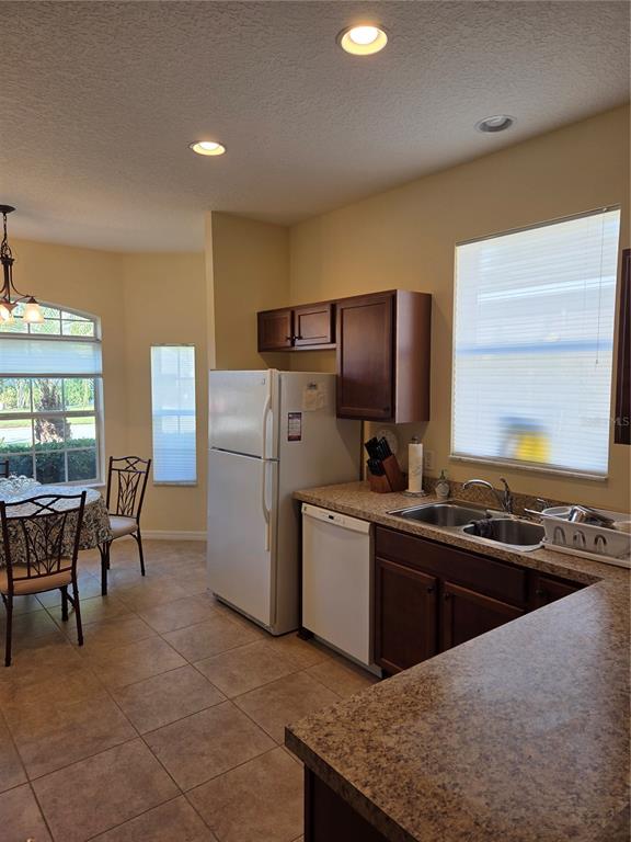 527 Safe Harbor Drive Edgewater, FL 32141 - Photo 6 of 33 a kitchen with refrigerator cabinets and dining table