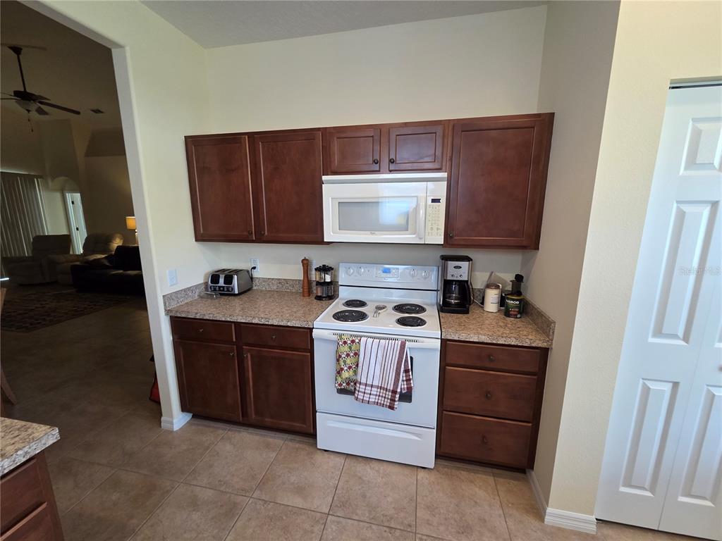 527 Safe Harbor Drive Edgewater, FL 32141 - Photo 9 of 33 a kitchen with a stove and a microwave
