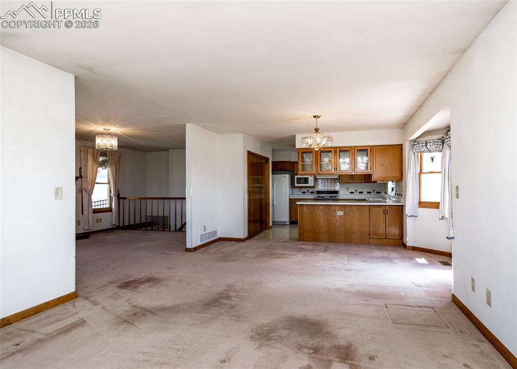 6185 Sayres Road Colorado Springs, CO 80927 - Photo 11 of 50 a view of kitchen with refrigerator and white cabinets