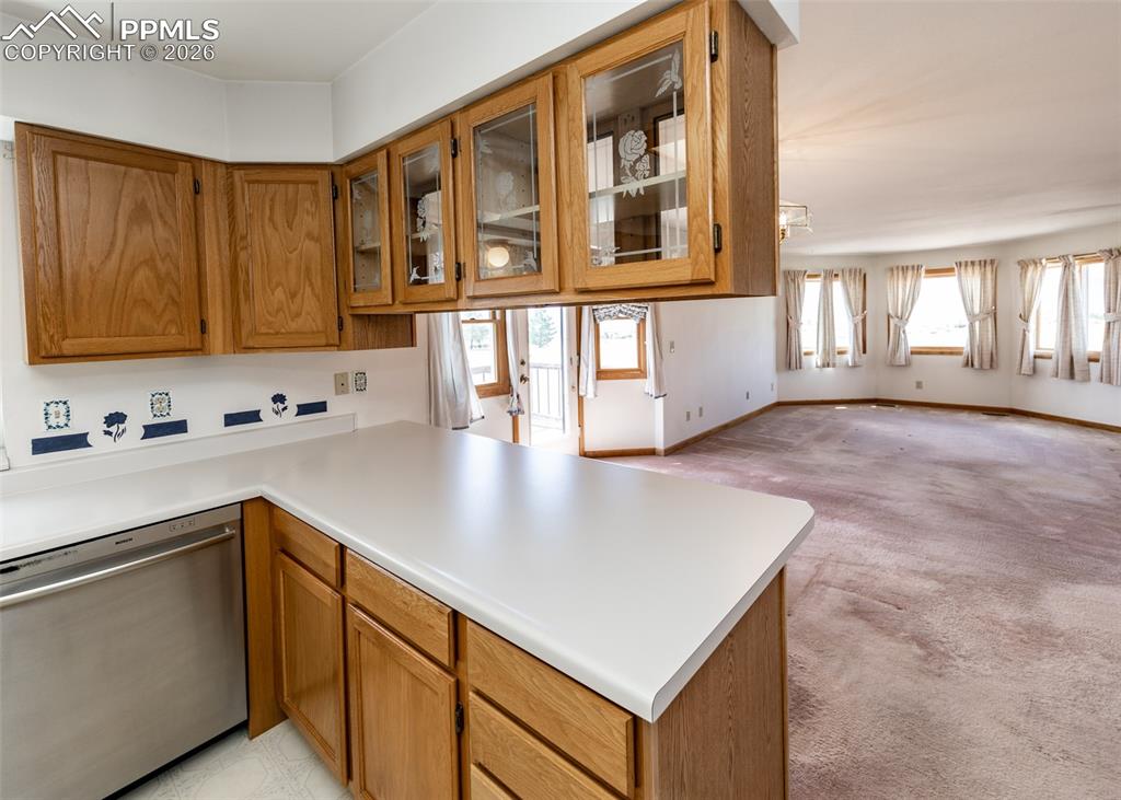 6185 Sayres Road Colorado Springs, CO 80927 - Photo 16 of 50 a kitchen with stainless steel appliances granite countertop a sink a stove and a wooden cabinets