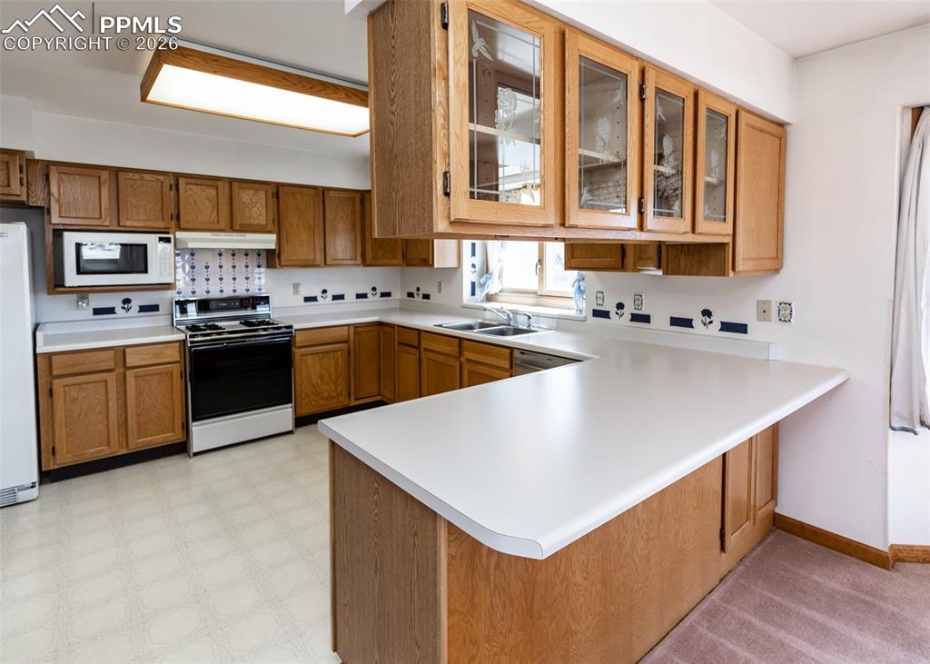 6185 Sayres Road Colorado Springs, CO 80927 - Photo 17 of 50 a kitchen that has a sink and a stove in it