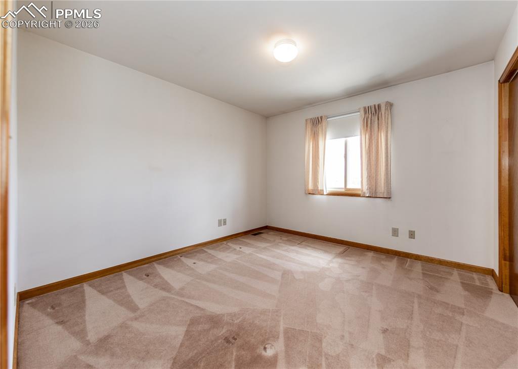 6185 Sayres Road Colorado Springs, CO 80927 - Photo 18 of 50 an empty room with windows